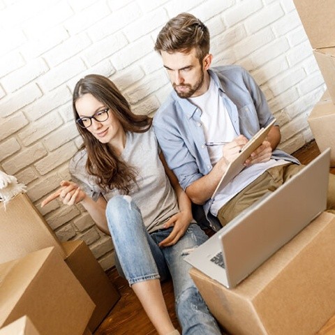 couple with laptop and boxes