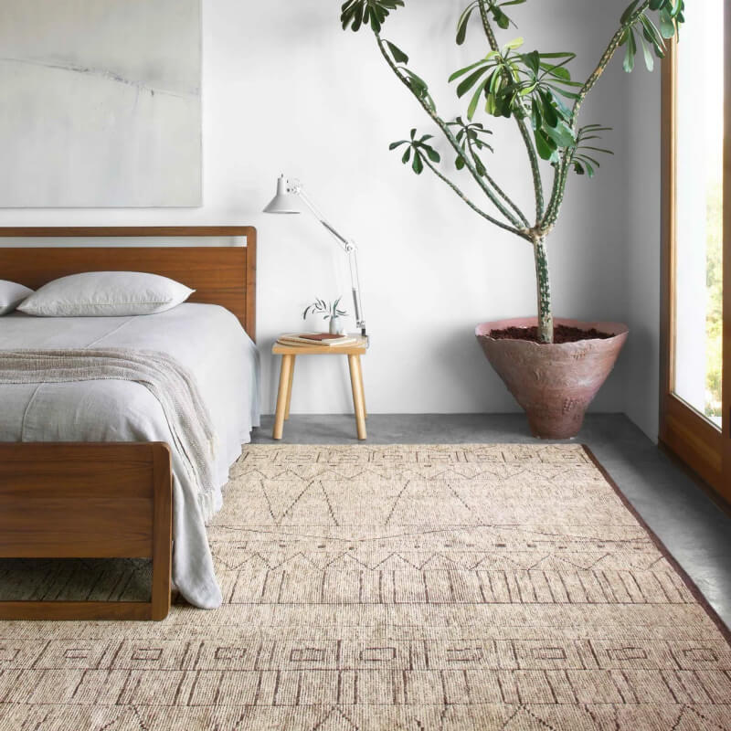 textured, patterned area rug in a bedroom