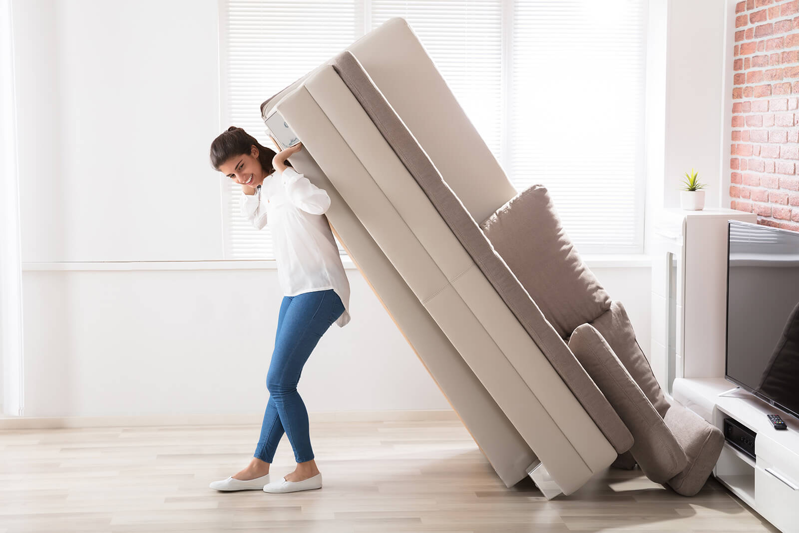 Woman moving sofa | Classic Flooring Center