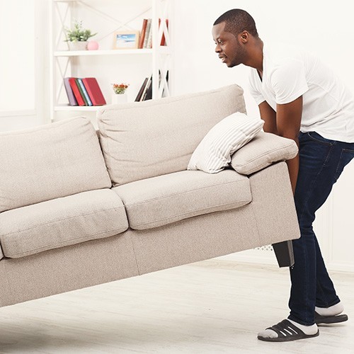 Man moving sofa | Classic Flooring Center