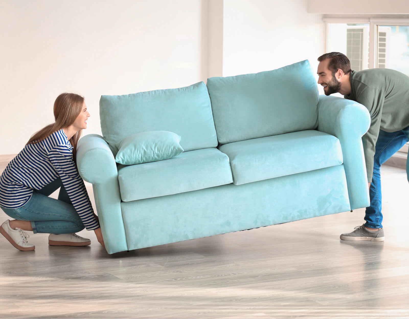 Couple moving sofa | Classic Flooring Center