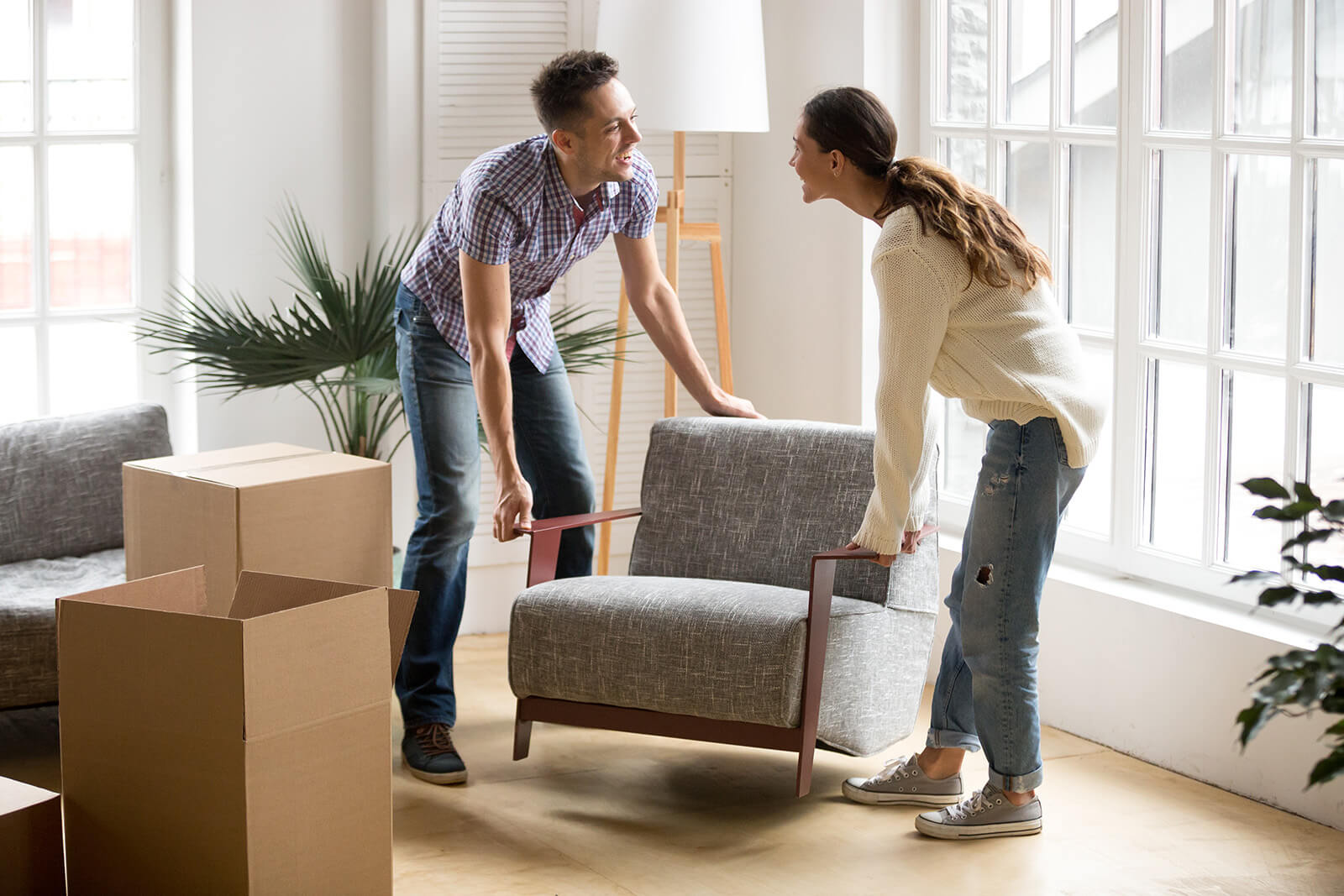 Couple moving sofa | Classic Flooring Center