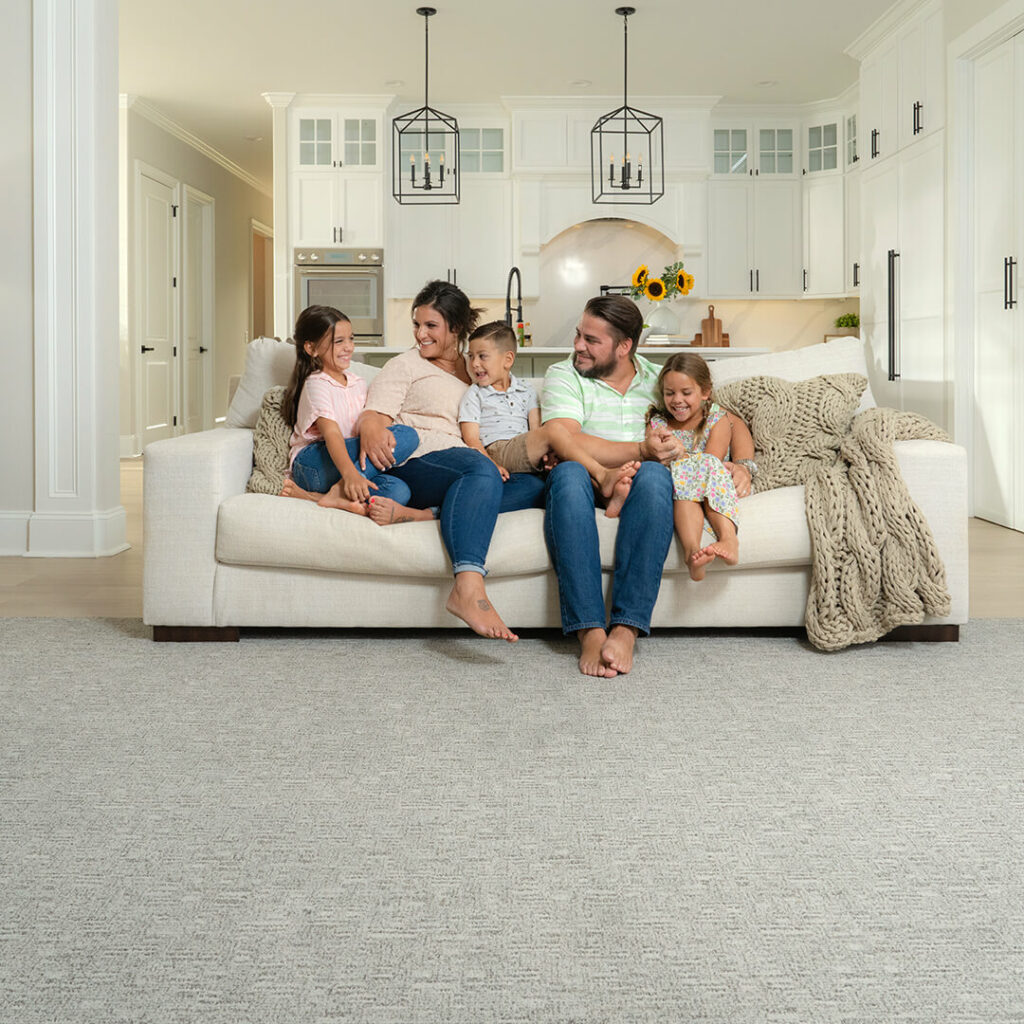 family sitting on couch in a living room