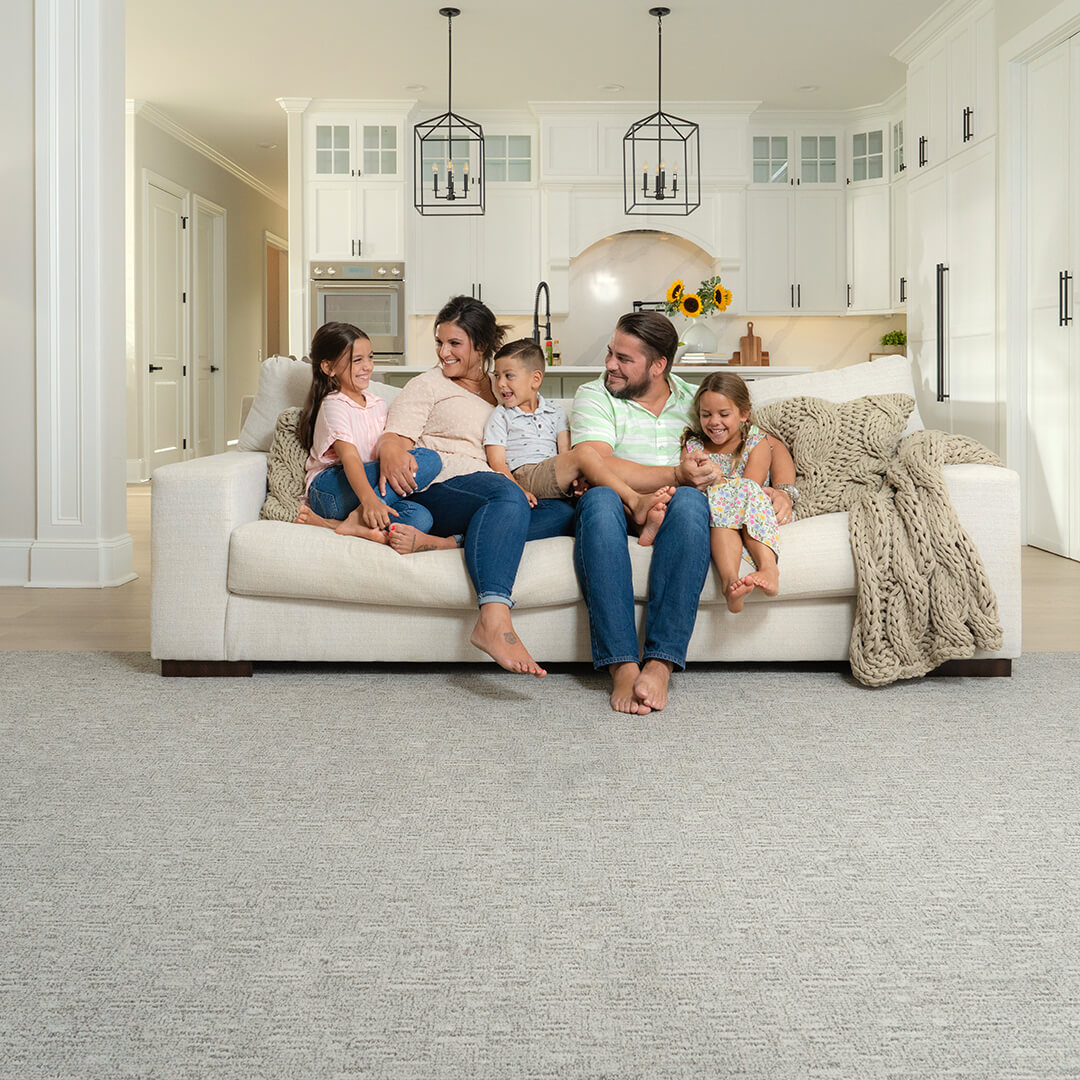 family sitting on couch in a living room 