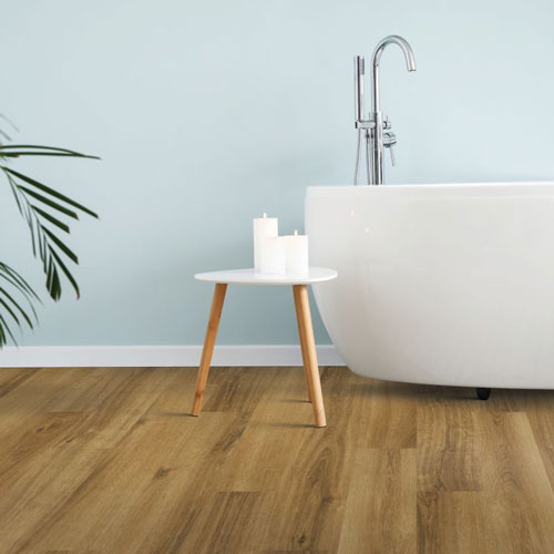 neutral colored wood look luxury vinyl plank flooring in a bathroom 