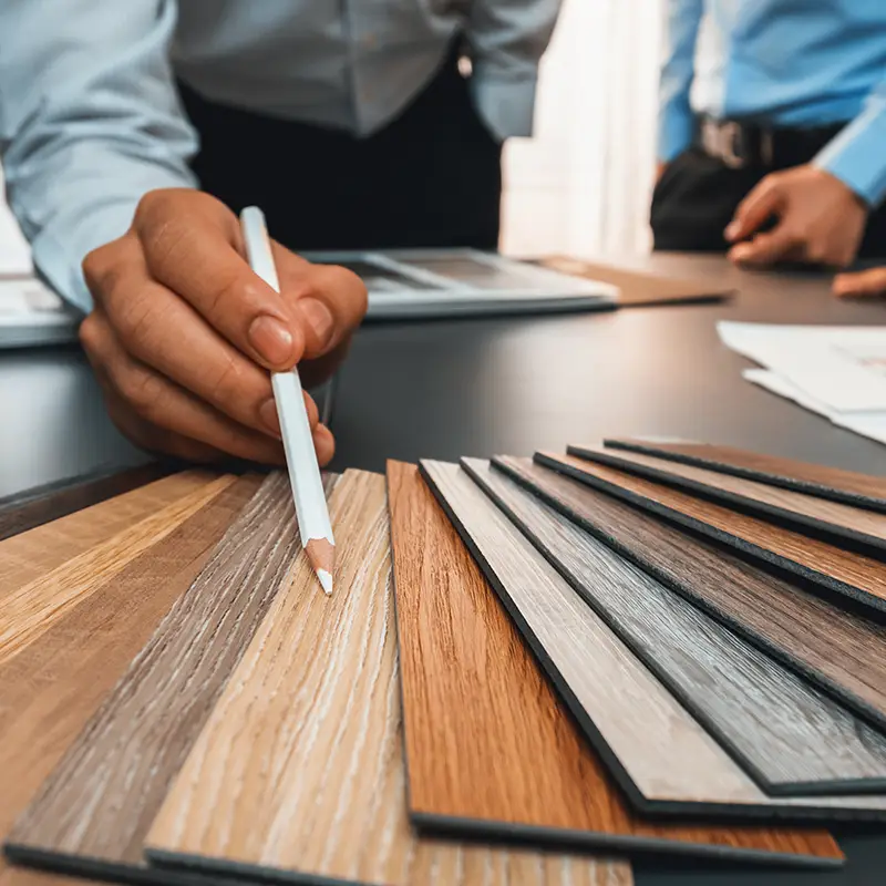 looking at samples of wood flooring while planning a renovation