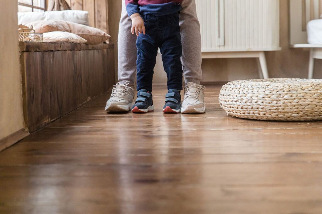 adult and child feet on resilient flooring 